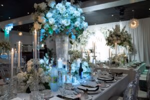 Elegant wedding reception table with floral centerpieces and candles at Oasis Convention Centre