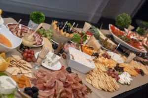 Gourmet charcuterie and cheese display with meats, fruits, and crackers at Oasis Convention Centre event reception