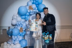 Baby shower celebration with blue balloon decor and cake at Oasis Convention Centre