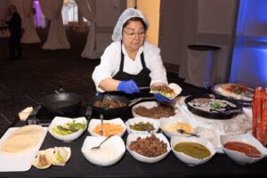 Chef preparing fresh tacos at a live food station during an event at Oasis Convention Centre