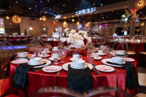 Elegant banquet table setup with red linens and floral centerpiece at Oasis Convention Centre