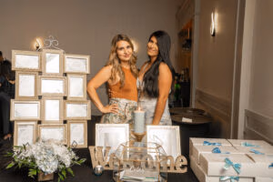 Baptism celebration welcome table with favors and cards display at Oasis Convention Centre